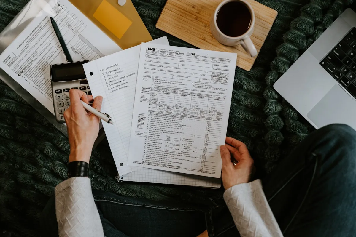 Working through a household financial plan with documents, calculator and coffee